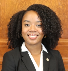 woman in black blazer smiling