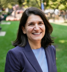 woman in dark blue blazer smiling