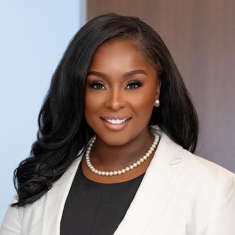 woman in a suit posing for a photograph