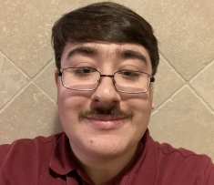 selfie of a man with glasses and a moustache