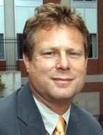 man in a suit posing for a photograph