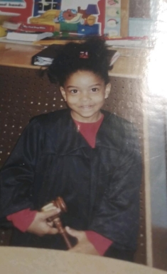 girl dressed up as a judge and holding a gavel