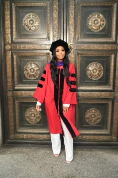 girl in law school graduation robes