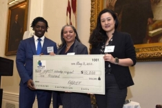 woman receiving a giant check and posing for a photograph