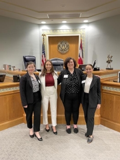 group of women in suits posing for a photograph