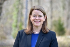 woman in a suit posing for a photograph