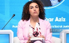 woman sitting next to a microphone