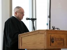 man speaking behind a podium