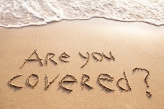 Photograph of "Are you Covered" writing on the beach