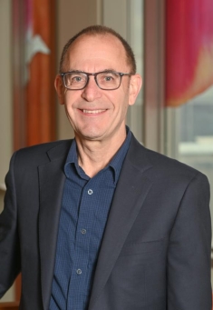 Man in a suit posing for a photograph