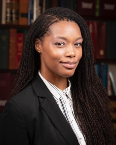 woman in a suit posing for a photograph