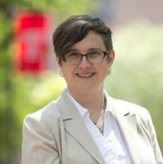 woman in a suit posing for a photograph
