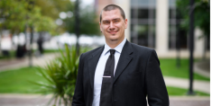 man in a suit posing for a photograph