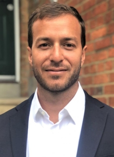man in a suit posing for a photograph