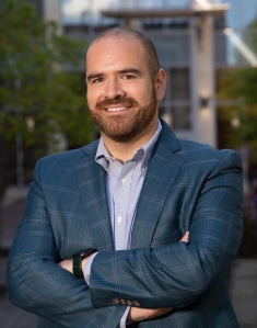 man in a suit posing for a photograph