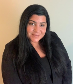 woman in a suit posing for a photograph