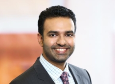 Man in a suit posing for a photograph