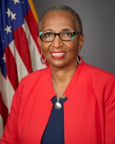 woman in a red suit posing for a photograph