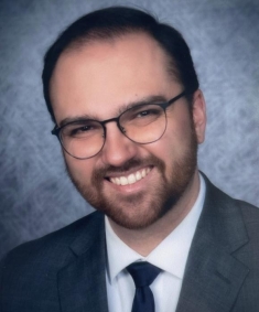 man in a suit posing for a photograph