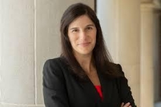woman in a suit posing for a photograph