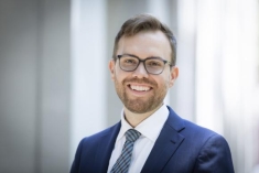 man in a suit posing for a photograph