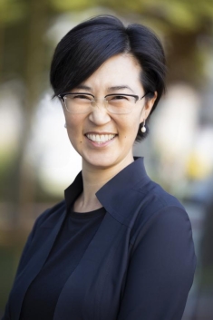 woman in a suit posing for a photograph