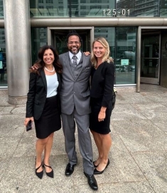 Group of people in suits posing for a photograph