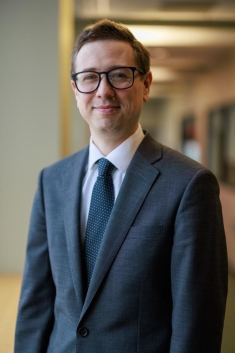 man in a suit posing for a photograph