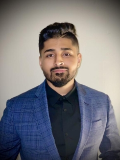 man in a suit posing for a photograph