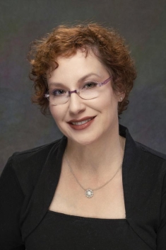 woman in a suit posing for a photograph