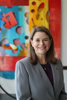 Woman in a suit posing for a photograph