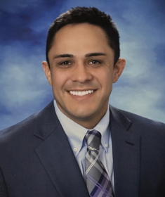 man in a suit posing for a photograph