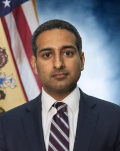 man in a suit posing for a photograph