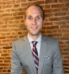 man in a suit posing for a photograph