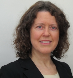 Woman grinning wearing black suit jacket