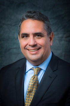 man in a suit posing for a photograph