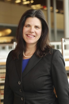 woman in a suit posing for a photograph