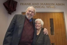 man and woman posing for a photograph