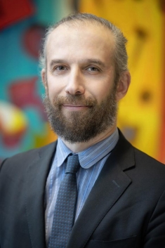 man in a suit posing for a photograph