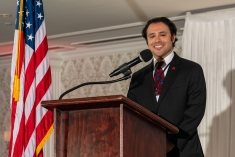Man smiling at podium