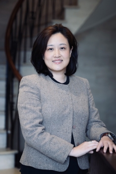 woman smiling with hand on dresser