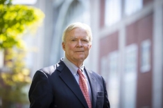 man in a suit posing for a photograph