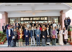 three rows of men and women standing on university steps