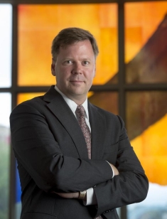 man in a suit posing for a photograph