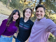 mom, dad, and teenage son smiling