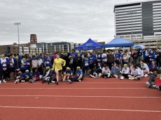 large crowd of youth runners on the side of race track