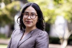 woman grinning wearing glasses outdoors