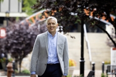 man in blazer and shirt walking outdoors