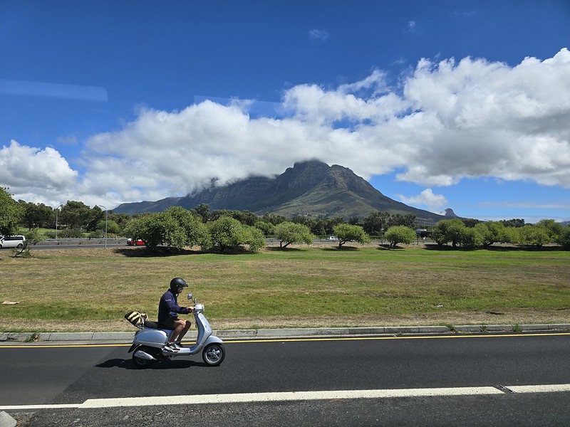 biker riding by table mountain in south africa