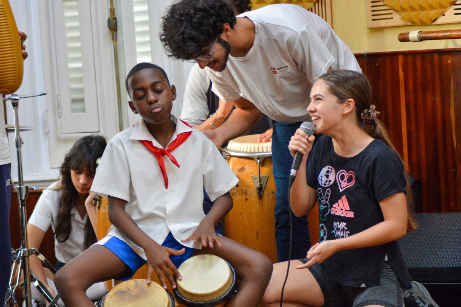 student playing bongo and student singing in cuban school